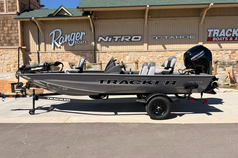 The Image of 2027 Tracker Pro Team 175 boat on trailer, displayed outside dealership. - 0