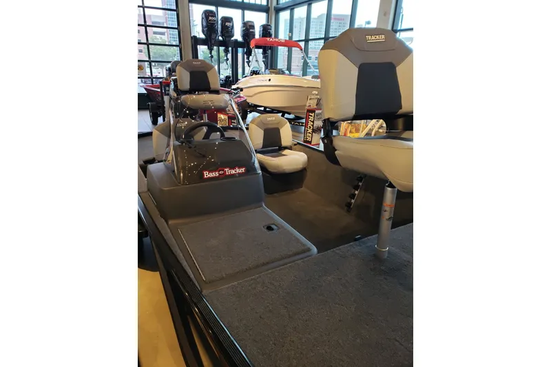 Slide: The Image of 2027 Tracker Bass Tracker Classic XL boat interior with seating and steering console. - 14