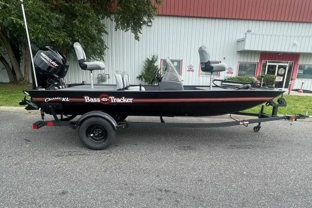 The Image of 2027 Tracker Bass Tracker Classic XL boat on trailer, parked outdoors. - 0