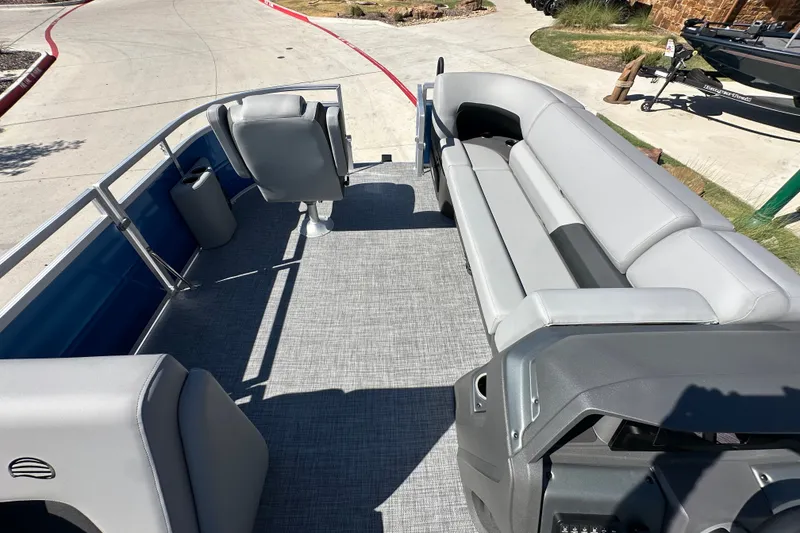 Slide: The Image of 2027 Sun Tracker SportFish 20 DLX pontoon boat interior with gray seating and spacious layout. - 30