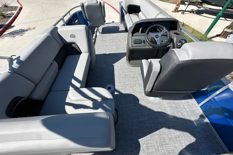 Slide: The Image of Interior of 2027 Sun Tracker SportFish 20 DLX pontoon boat with gray seating and steering console. - 28
