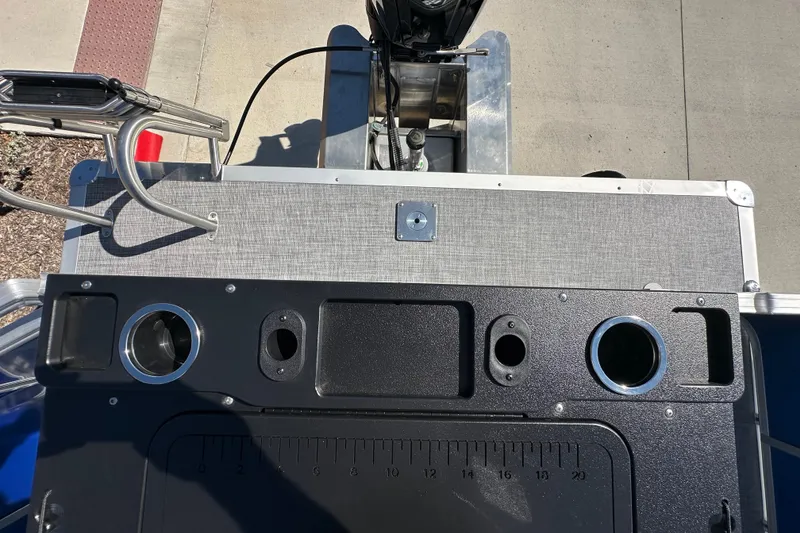 Slide: The Image of 2027 Sun Tracker SportFish 20 DLX boat deck with cup holders and fishing rod slots. - 26