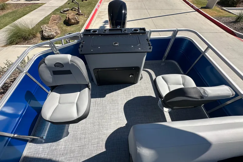 Slide: The Image of 2027 Sun Tracker SportFish 20 DLX pontoon boat interior with seating and console. - 21