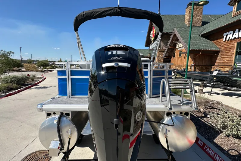 Slide: The Image of 2027 Sun Tracker SportFish 20 DLX pontoon boat with Mercury 115 engine, parked outdoors. - 14