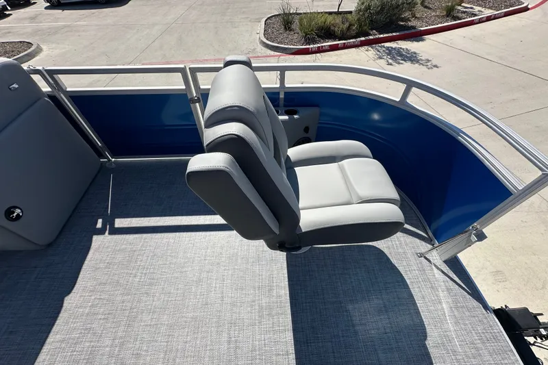 Slide: The Image of 2027 Sun Tracker SportFish 20 DLX boat interior with gray seating and blue railing. - 31