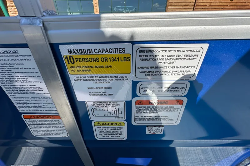 Slide: The Image of 2027 Sun Tracker SportFish 20 DLX capacity and emissions labels, maximum 10 persons or 1341 lbs. - 29