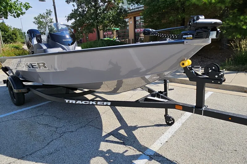 The Image of 2027 Tracker Super Guide V-16 SC boat on trailer in parking lot. - 0