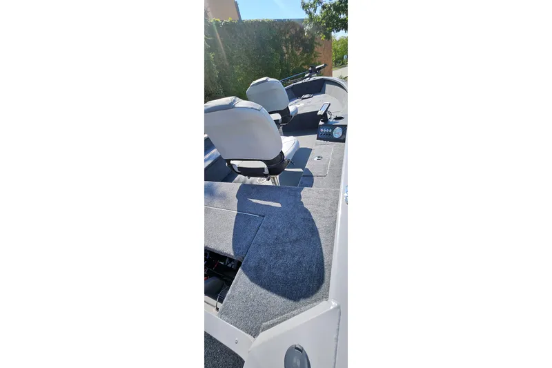 Slide: The Image of 2027 Tracker Super Guide V-16 T boat interior with seating and control panel. - 41