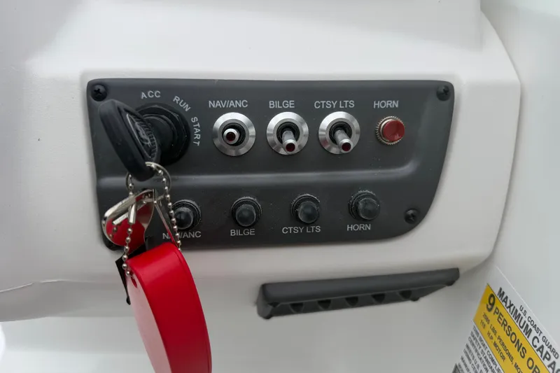 Slide: The Image of Control panel of a 2027 Tahoe T18 boat with ignition and switches. - 7