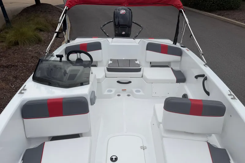 Slide: The Image of 2027 Tahoe T18 boat interior with red and gray seating, steering wheel, and windshield. - 5