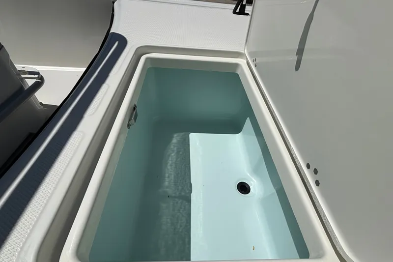 Slide: The Image of Open storage compartment on 2027 Mako Pro Skiff 17 CC boat. - 11