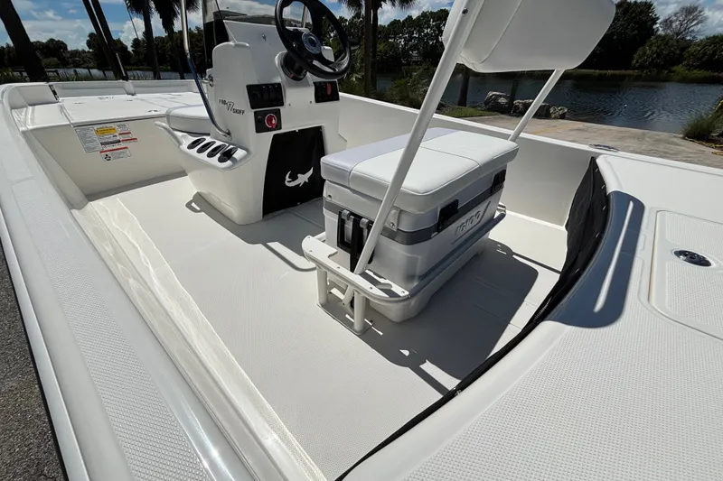 Slide: The Image of 2027 Mako Pro Skiff 17 CC boat interior with seating and steering console. - 9