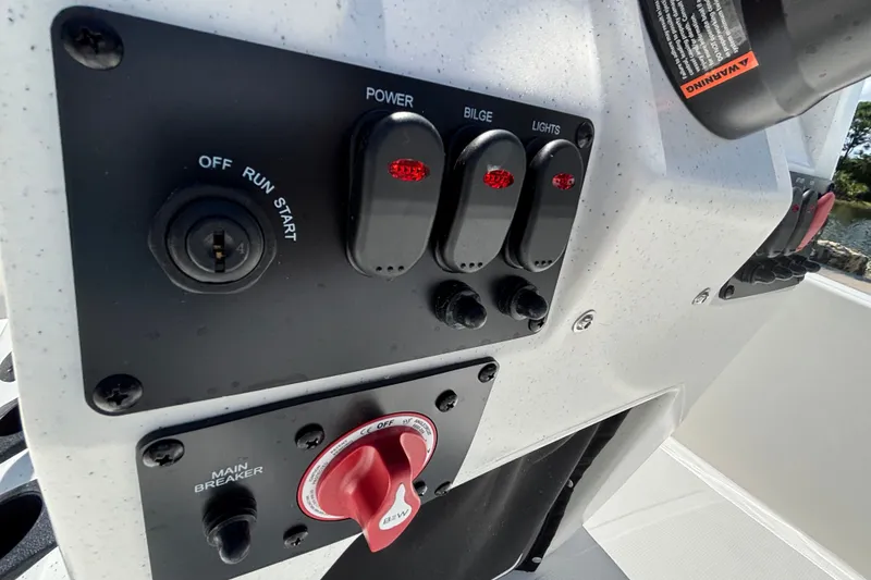 Slide: The Image of Control panel of a 2027 Mako Pro Skiff 17 CC boat with switches and ignition. - 10