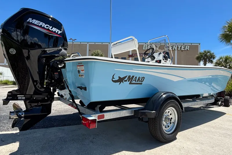 Slide: The Image of 2027 Mako Pro Skiff 17 CC boat with Mercury engine on trailer, parked outdoors. - 4