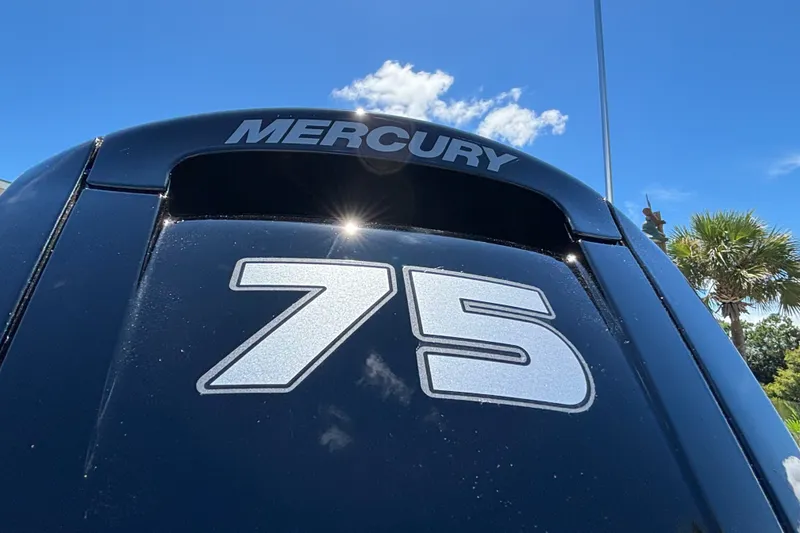 Slide: The Image of Mercury 75 horsepower engine on 2027 Mako Pro Skiff 17 CC under clear blue sky. - 5