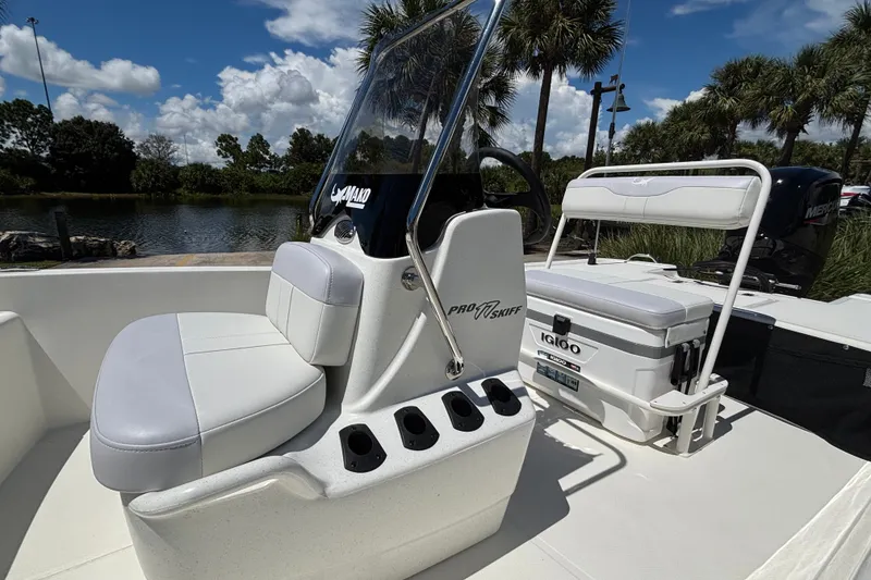 Slide: The Image of 2027 Mako Pro Skiff 17 CC boat interior with seating and Igloo cooler. - 8
