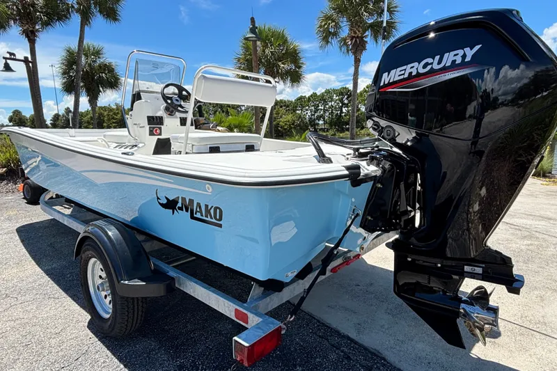 Slide: The Image of 2027 Mako Pro Skiff 17 CC boat with Mercury engine on trailer, parked outdoors. - 3