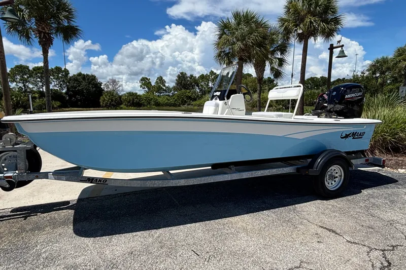 The Image of 2027 Mako Pro Skiff 17 CC boat on trailer, parked outdoors under palm trees. - 0