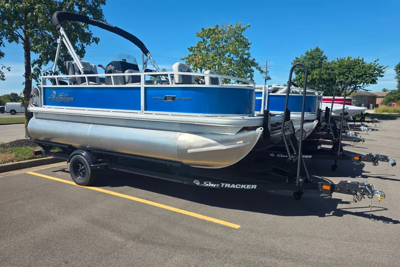 The Image of 2027 Sun Tracker Bass Buggy 16 XL Select pontoon boat in parking lot. - 0