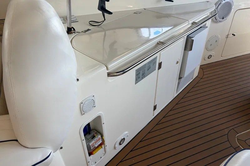 Slide: The Image of Interior of 1997 Sunseeker Camargue 51 yacht with sleek white cabinetry and wood flooring. - 13