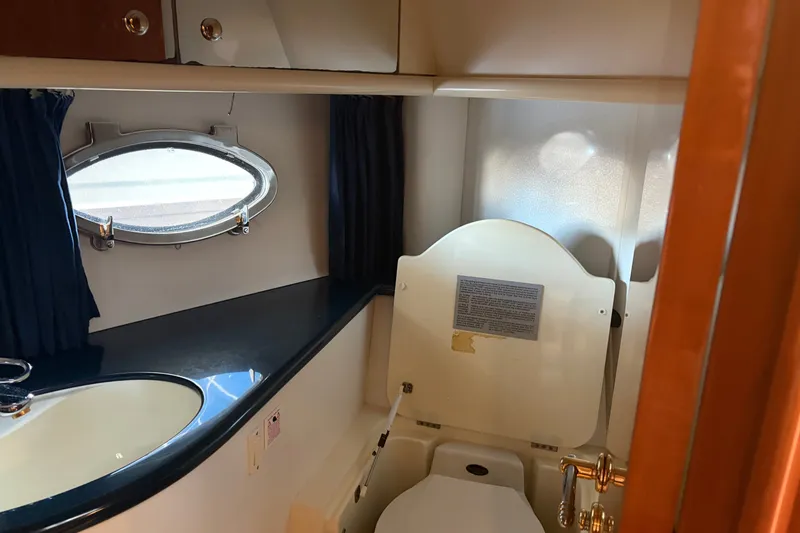 Slide: The Image of Bathroom interior of 1997 Sunseeker Camargue 51 yacht with porthole and sink. - 31