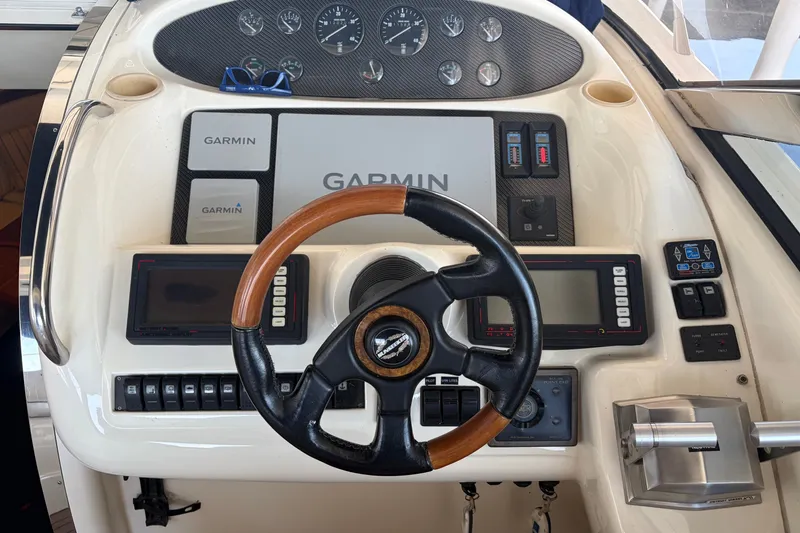 Slide: The Image of Sunseeker Camargue 51 helm with Garmin navigation, 1997 model, featuring wood-accented steering wheel. - 16