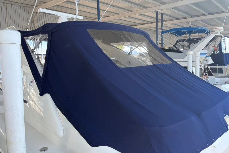 Slide: The Image of 1997 Sunseeker Camargue 51 yacht with blue canvas cover in marina. - 4