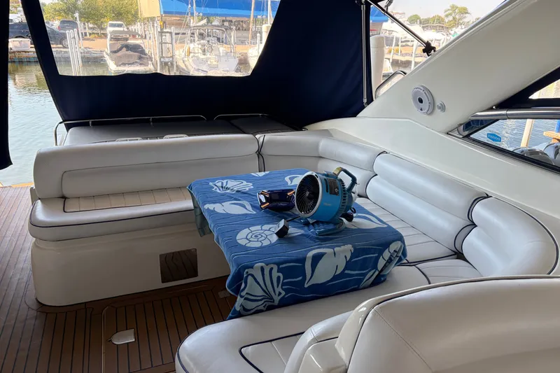 Slide: The Image of Interior of 1997 Sunseeker Camargue 51 yacht with white seating and blue tablecloth. - 8