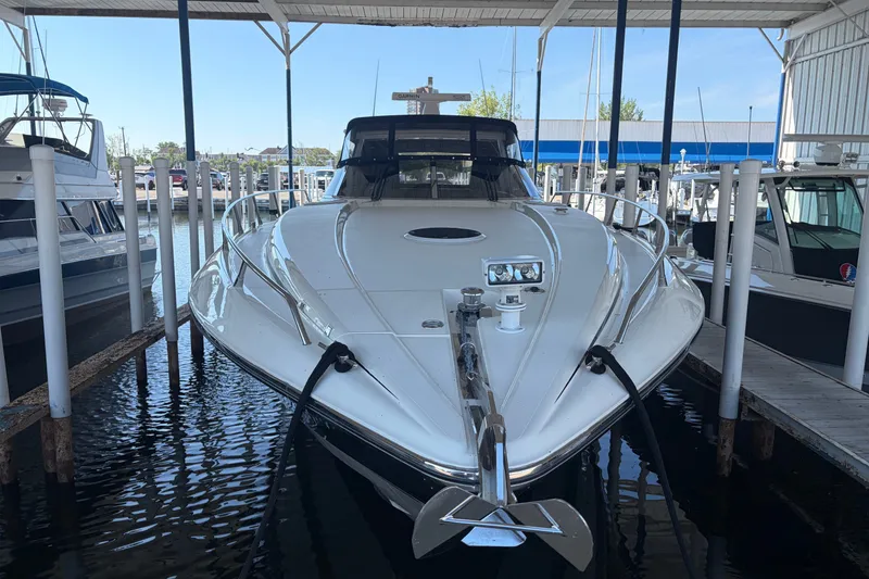 Slide: The Image of 1997 Sunseeker Camargue 51 yacht docked in a marina under a covered slip. - 2