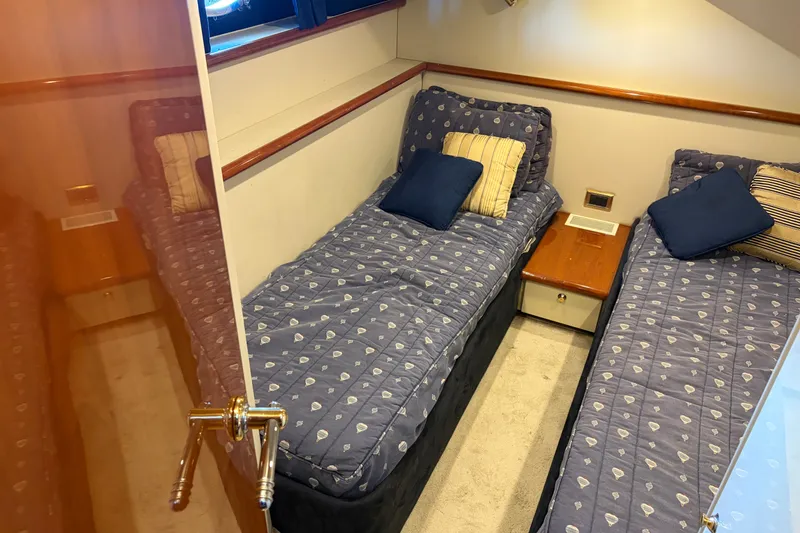 Slide: The Image of Twin beds in a cozy cabin of a 1997 Sunseeker Camargue 51 yacht. - 38