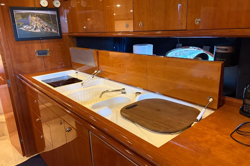 Slide: The Image of Luxurious kitchen area in a 1997 Sunseeker Camargue 51 yacht with wooden cabinetry. - 37
