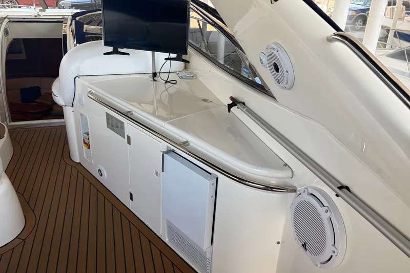 Slide: The Image of 1997 Sunseeker Camargue 51 yacht interior with TV, speakers, and storage cabinets. - 14