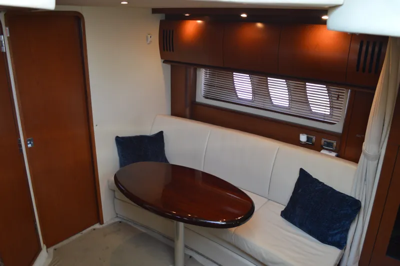 Slide: The Image of Interior of 2007 Sea Ray 38 Sundancer yacht with elegant seating and wooden table. - 28