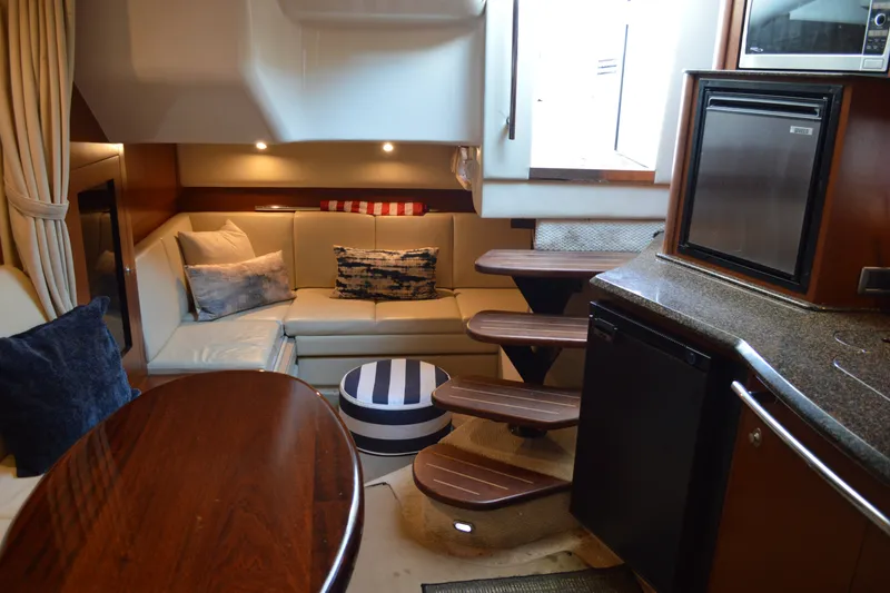 Slide: The Image of Luxurious interior of 2007 Sea Ray 38 Sundancer yacht with cozy seating and kitchenette. - 20