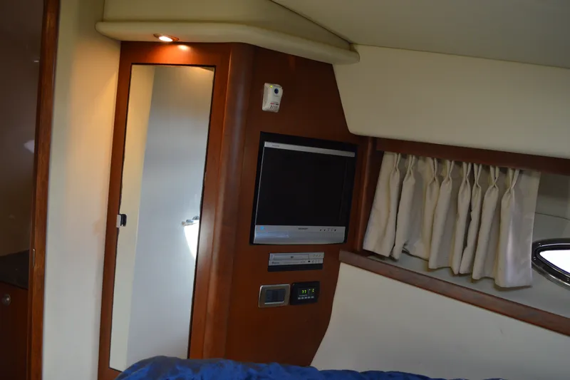 Slide: The Image of Interior of 2007 Sea Ray 38 Sundancer with TV, mirror, and curtains. - 32