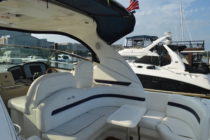 Slide: The Image of 2007 Sea Ray 38 Sundancer yacht interior with white seating, docked at marina. - 8