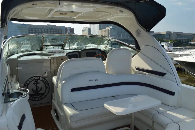 Slide: The Image of 2007 Sea Ray 38 Sundancer yacht interior with white seating and helm, docked at marina. - 6