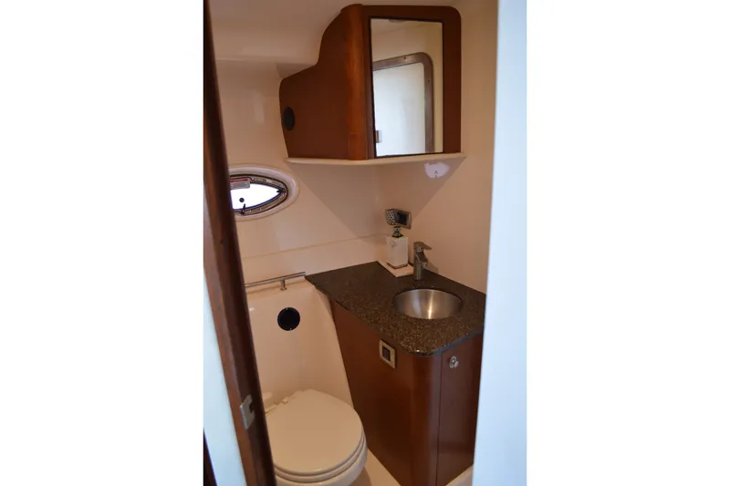 Slide: The Image of 2007 Sea Ray 38 Sundancer bathroom with sink, mirror, and porthole window. - 33