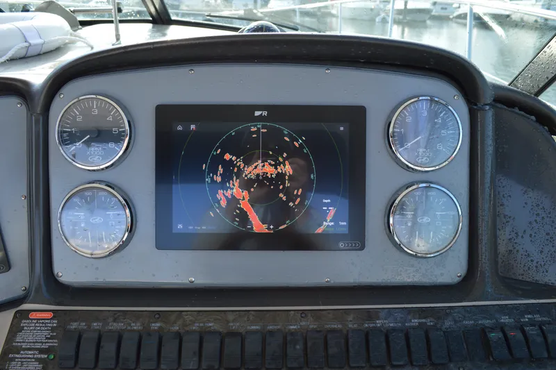 Slide: The Image of Dashboard of 2007 Sea Ray 38 Sundancer with radar display and gauges. - 11