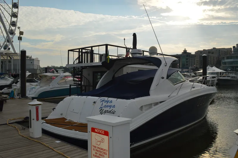 Slide: The Image of 2007 Sea Ray 38 Sundancer yacht docked at marina under cloudy sky. - 36