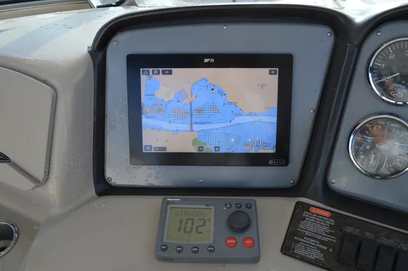 Slide: The Image of Navigation system on a 2007 Sea Ray 38 Sundancer boat dashboard. - 12