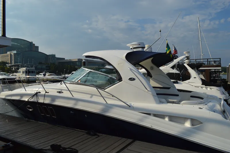 Slide: The Image of 2007 Sea Ray 38 Sundancer yacht docked at marina under clear sky. - 4