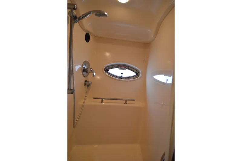 Slide: The Image of Shower area in 2007 Sea Ray 38 Sundancer yacht with chrome fixtures and porthole window. - 35
