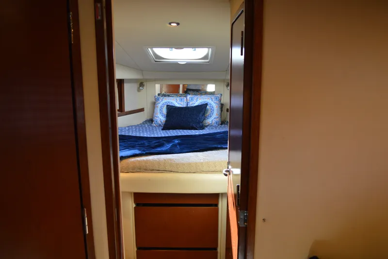 Slide: The Image of Interior cabin of 2007 Sea Ray 38 Sundancer with cozy bedding and skylight. - 29