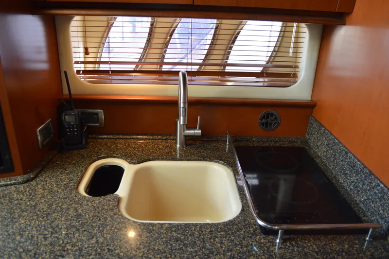 Slide: The Image of Luxurious 2007 Sea Ray 38 Sundancer yacht kitchen with granite countertop and modern appliances. - 24