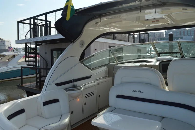 Slide: The Image of 2007 Sea Ray 38 Sundancer yacht interior with white seating and modern dashboard. - 7