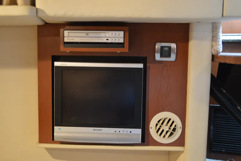 Slide: The Image of Entertainment system in 2007 Sea Ray 38 Sundancer yacht, featuring a Sharp TV and DVD player. - 26