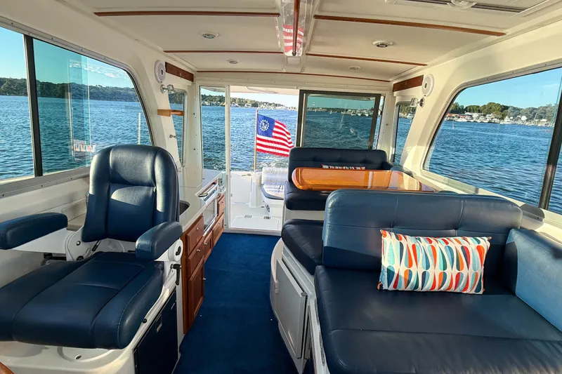 Slide: The Image of Interior of 2016 Back Cove 34 boat with blue seating and lake view. - 33
