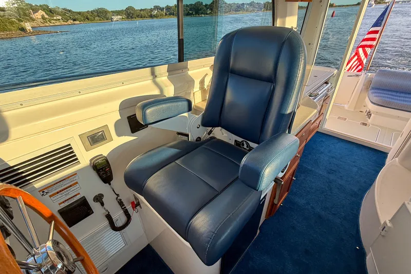 Slide: The Image of Captain's chair on 2016 Back Cove 34 boat, overlooking serene waters. - 20