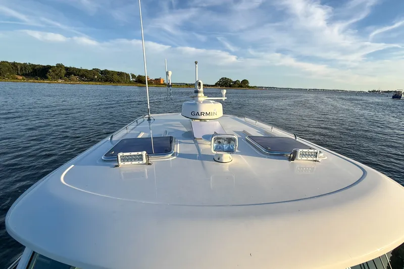Slide: The Image of 2016 Back Cove 34 boat with Garmin equipment on calm water, scenic shoreline view. - 39